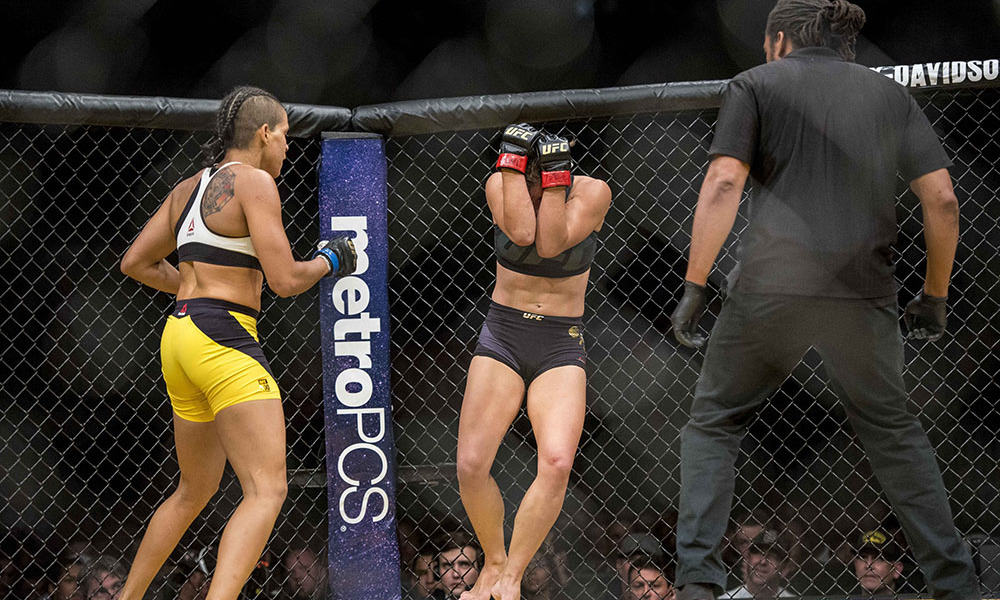 Jul 9, 2016; Las Vegas, NV, USA; Amanda Nunes (blue gloves) and Miesha Tate (red gloves) compete during UFC 200 at T-Mobile Arena. Nunez won by rear naked choke. Mandatory Credit: Joshua Dahl-USA TODAY Sports