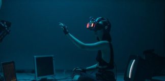 The Future of Online Gambling: Trends to Watch in 2025 Woman immersed in virtual reality, surrounded by tech, in a dimly lit room.
